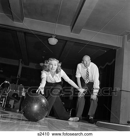 1950 1950S Woman Just Threw Bowling Ball Down Alley Man Watching View Large Photo Image Stock Image - 1950 1950S Woman Just Threw Bowling Ball Down Alley Man Watching . Fotosearch