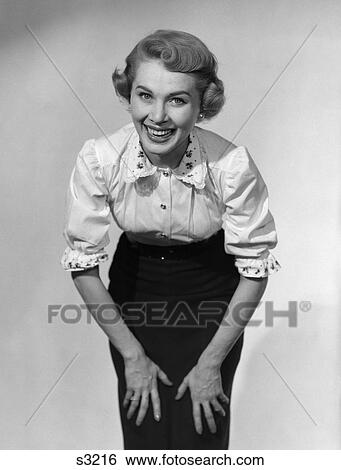 1950 1950S Woman Posing With Hands On Knees Smiling View Large Photo Image Stock Photograph - 1950 1950S Woman Posing With Hands On Knees Smiling . Fotosearch