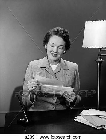 1950 1950S Woman Sitting At Desk Going Through Mail View Large Photo Image Stock Image - 1950 1950S Woman Sitting At Desk Going Through Mail . Fotosearch
