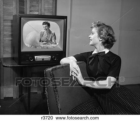 1950 1950S Woman Sitting In Chair Watching Television Woman Looking Into Bassinet Pointing Finger View Large Photo Image Stock Image - 1950 1950S Woman Sitting In Chair Watching Television Woman Looking Into Bassinet Pointing Finger . Fotosearch