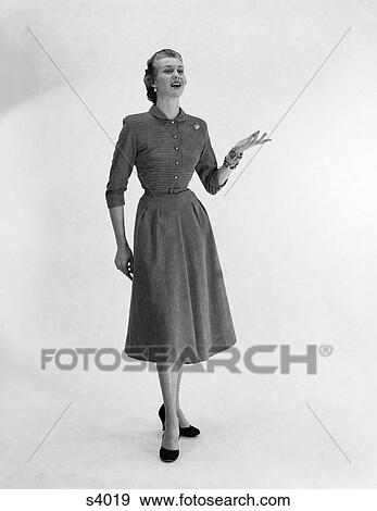 Stock Photo - 1950 1950S Woman Standing Holding Arm Out Talking . Fotosearch