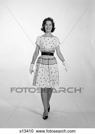 1950 1950S Woman Standing Smiling Wearing Dress And Gloves View Large Photo Image Stock Image - 1950 1950S Woman Standing Smiling Wearing Dress And Gloves . Fotosearch