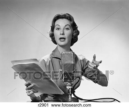 1950 1950S Woman Talking Into Microphone Holding Papers With Exaggerated Expression View Large Photo Image Stock Image - 1950 1950S Woman Talking Into Microphone Holding Papers With Exaggerated Expression . Fotosearch
