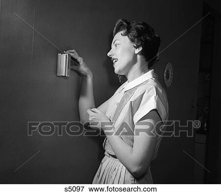 1950 1950S Woman Using Thermostat View Large Photo Image Stock Photo - 1950 1950S Woman Using Thermostat . Fotosearch