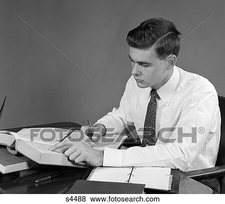 Stock Photo - 1950 1950S Young Man Sitting At Desk Studying . Fotosearch