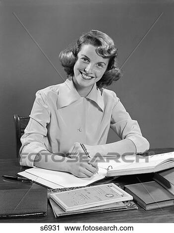 1950 1950S Young Woman Smiling At Desk Writing And Studying View Large Photo Image Stock Image - 1950 1950S Young Woman Smiling At Desk Writing And Studying . Fotosearch
