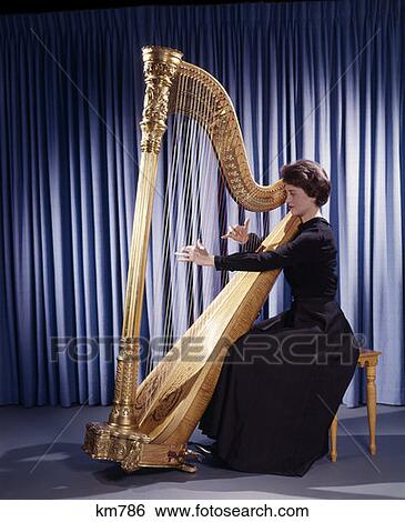 1950S 1960S 1970S Retro Woman Musician Playing Large Classical Harp Instrument View Large Photo Image Stock Photograph - 1950S 1960S 1970S Retro Woman Musician Playing Large Classical Harp Instrument. Fotosearch