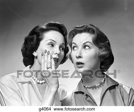 1950S 1960S 2 Women Gossiping One Whispers Into The Ear Of The Other View Large Photo Image Picture - 1950S 1960S 2 Women Gossiping One Whispers Into The Ear Of The Other . Fotosearch