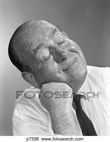 1950S 1960S Bald Man Leaning Head On Fist Hand Shirt Tie Eyes Closed Smiling Thinking Funny Face Expression Character View Large Photo Image Stock Photograph - 1950S 1960S Bald Man Leaning Head On Fist Hand Shirt Tie Eyes Closed Smiling Thinking Funny Face Expression Character . Fotosearch