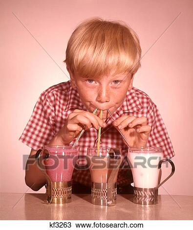 1950S 1960S Blond Boy Drinking Three Strawberry Chocolate Vanilla Milkshake Through A Straw At Same Time View Large Photo Image Stock Image - 1950S 1960S Blond Boy Drinking Three Strawberry Chocolate Vanilla Milkshake Through A Straw At Same Time . Fotosearch