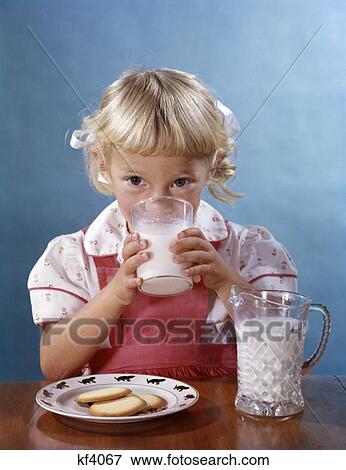 1950S 1960S Blonde Girl Drinking Milk Plate Cookies View Large Photo Image Stock Photo - 1950S 1960S Blonde Girl Drinking Milk Plate Cookies . Fotosearch