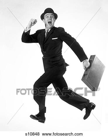 1950S 1960S Happy Excited Exuberant Man Jumping In Air Running Carrying Attache Case Briefcase Wearing Business Suit Hat View Large Photo Image Stock Photo - 1950S 1960S Happy Excited Exuberant Man Jumping In Air Running Carrying Attache Case Briefcase Wearing Business Suit Hat . Fotosearch