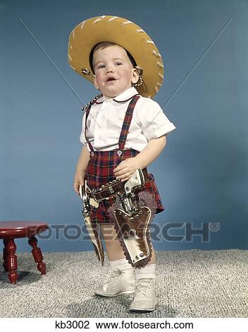 1950'S 1960'S Little Boy Wearing Cowboy Hat And Two Six Gun Cap Pistols Holsters Standing With Attitude Retro View Large Photo Image Stock Image - 1950'S 1960'S Little Boy Wearing Cowboy Hat And Two Six Gun Cap Pistols Holsters Standing With Attitude Retro . Fotosearch