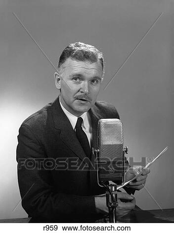1950S 1960S Older Man Speaking Into Microphone Holding Papers Radio Television Newsman Reporter Announcer View Large Photo Image Stock Photo - 1950S 1960S Older Man Speaking Into Microphone Holding Papers Radio Television Newsman Reporter Announcer . Fotosearch