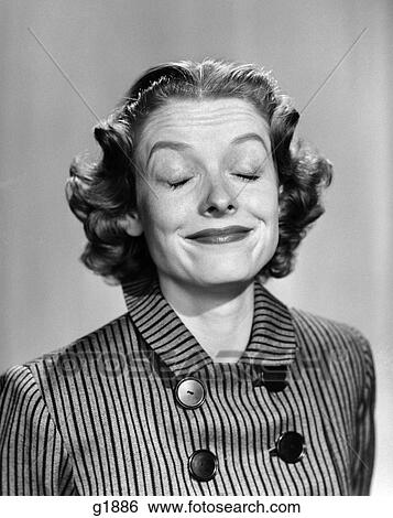 1950S 1960S Portrait Woman Smiling Eyes Closed Making A Funny Face Wearing A Striped Dress With Buttons View Large Photo Image Stock Photograph - 1950S 1960S Portrait Woman Smiling Eyes Closed Making A Funny Face Wearing A Striped Dress With Buttons . Fotosearch