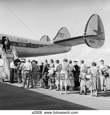 1950S 1960S Rear Tail Of Airplane With Passengers On Tarmac In Line Row Wait To Enter Board Stairs Travel Load Embark View Large Photo Image Stock Photo - 1950S 1960S Rear Tail Of Airplane With Passengers On Tarmac In Line Row Wait To Enter Board Stairs Travel Load Embark . Fotosearch