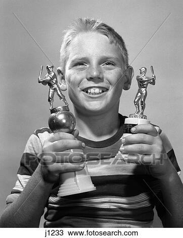 1950S 1960S Smiling Boy Holding Two Baseball Trophies Trophy Award Little League View Large Photo Image Stock Image - 1950S 1960S Smiling Boy Holding Two Baseball Trophies Trophy Award Little League . Fotosearch