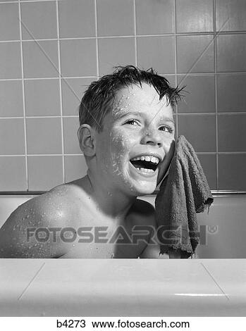 1950S 1960S Smiling Boy Washing Face Sitting In Bathtub View Large Photo Image Stock Image - 1950S 1960S Smiling Boy Washing Face Sitting In Bathtub . Fotosearch
