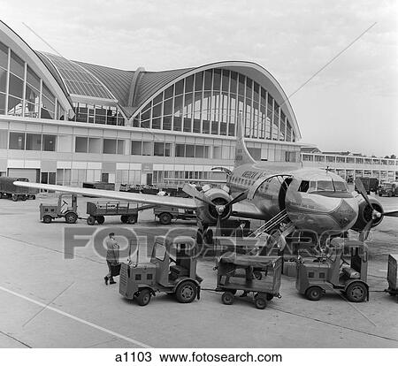 1950S 1960S St. Louis Missouri Airport Propeller Airplane On Tarmac Infront Of Terminal With Modern Arch & Window View Large Photo Image Stock Image - 1950S 1960S St. Louis Missouri Airport Propeller Airplane On Tarmac Infront Of Terminal With Modern Arch & Window . Fotosearch