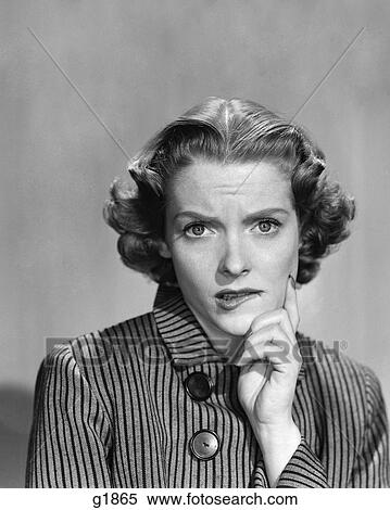 Stock Photography - 1950S 1960S Woman In Striped Dress With Buttons Hand To Chin Comic Worried Expression Looking At Camera . Fotosearch