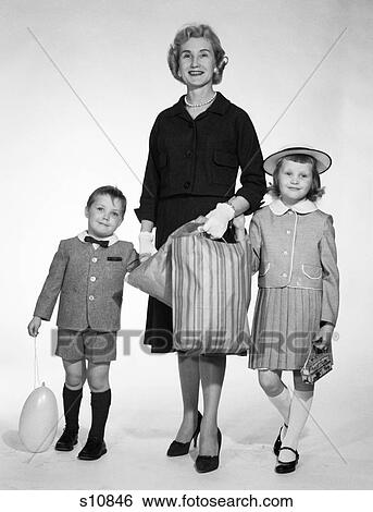 1950S 1960S Woman Mother Two Children Boy Girl Holding Hands Shopping Bag Dressed Up Son Shorts Pants Balloon Daughter Hat Skirt View Large Photo Image Stock Photograph - 1950S 1960S Woman Mother Two Children Boy Girl Holding Hands Shopping Bag Dressed Up Son Shorts Pants Balloon Daughter Hat Skirt. Fotosearch