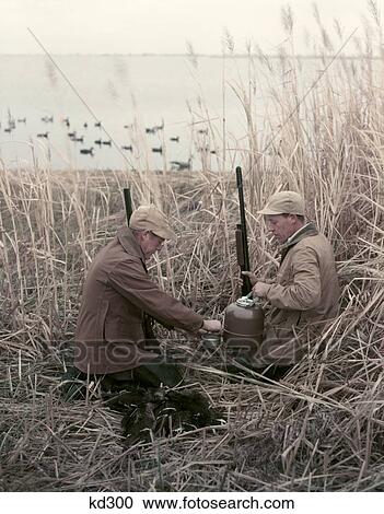 1950S 2 Men Hunters Tall Grass Reeds Duck Blind Brown Beige Hot Drink Thermos Shotguns Duck Decoys Water Lake Autumn View Large Photo Image Stock Image - 1950S 2 Men Hunters Tall Grass Reeds Duck Blind Brown Beige Hot Drink Thermos Shotguns Duck Decoys Water Lake Autumn. Fotosearch