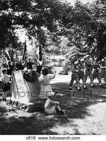 1950S A Boy And A Girl Stand By A Tombstone Waving To Passing Color Guard Of Soldiers In A Memorial Day Parade View Large Photo Image Stock Photograph - 1950S A Boy And A Girl Stand By A Tombstone Waving To Passing Color Guard Of Soldiers In A Memorial Day Parade. Fotosearch