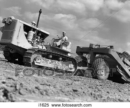 1950S Angled Worm'S-Eye View Of Man Pulling Levers On Bulldozer Hauling Scraper View Large Photo Image Stock Photography - 1950S Angled Worm'S-Eye View Of Man Pulling Levers On Bulldozer Hauling Scraper . Fotosearch