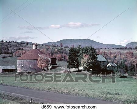 1950S Autumn Farm Scene Road Foreground Mountains On Horizon Round Barrel Shaped Bard Lowell Vermont View Large Photo Image Stock Photo - 1950S Autumn Farm Scene Road Foreground Mountains On Horizon Round Barrel Shaped Bard Lowell Vermont. Fotosearch