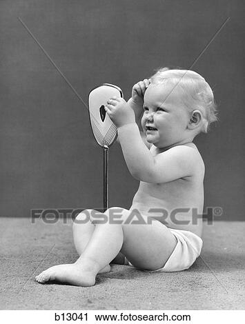1950S Baby Holding Mirror Looking At Hair View Large Photo Image Stock Image - 1950S Baby Holding Mirror Looking At Hair . Fotosearch
