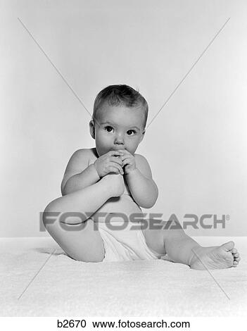 1950S Baby Seated On Carpet Bringing Foot To Mouth View Large Photo Image Stock Image - 1950S Baby Seated On Carpet Bringing Foot To Mouth . Fotosearch