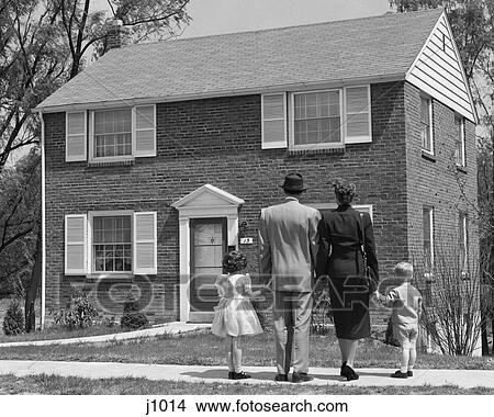 Picture - 1950S Back View Of Family Of 4 Standing In Front Of New Home Holding Hands . Fotosearch