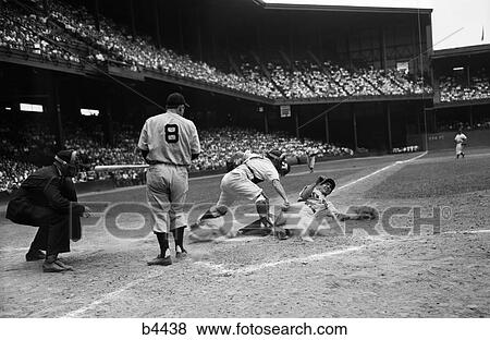 1950S Baseball Game Umpire And Player Watch As Catcher Stands Over Home Plate Base And Man Slides Into Home View Large Photo Image Stock Photo - 1950S Baseball Game Umpire And Player Watch As Catcher Stands Over Home Plate Base And Man Slides Into Home. Fotosearch