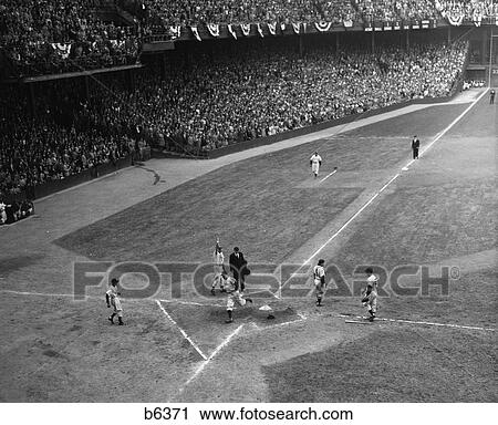 Stock Image - 1950S Baseball Player Scoring Home Run As He Strides Across Home Plate . Fotosearch