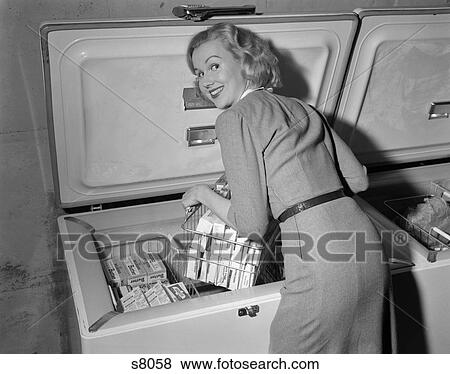 1950S Blonde Woman Lifting Wire Basket Food Items From A Deep Freezer Looking Over Her Shoulder View Large Photo Image Stock Photo - 1950S Blonde Woman Lifting Wire Basket Food Items From A Deep Freezer Looking Over Her Shoulder . Fotosearch