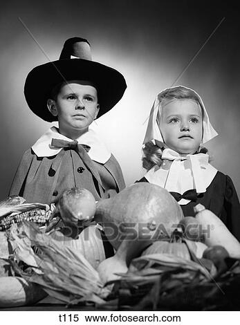 1950S Boy & Girl In Pilgrim Costumes With Harvest On Table In Front Of Them View Large Photo Image Stock Photography - 1950S Boy & Girl In Pilgrim Costumes With Harvest On Table In Front Of Them . Fotosearch