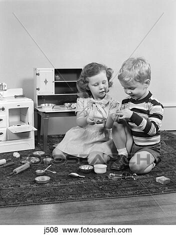 1950S Boy & Girl Playing House With Toy Stove & Pantry With Pots Pans Dishes And Cooking Utensils View Large Photo Image Stock Photo - 1950S Boy & Girl Playing House With Toy Stove & Pantry With Pots Pans Dishes And Cooking Utensils . Fotosearch