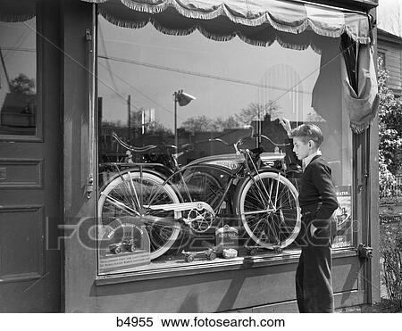 1950S Boy On Sidewalk Looking At Bicycle In Store Window View Large Photo Image Stock Photography - 1950S Boy On Sidewalk Looking At Bicycle In Store Window . Fotosearch
