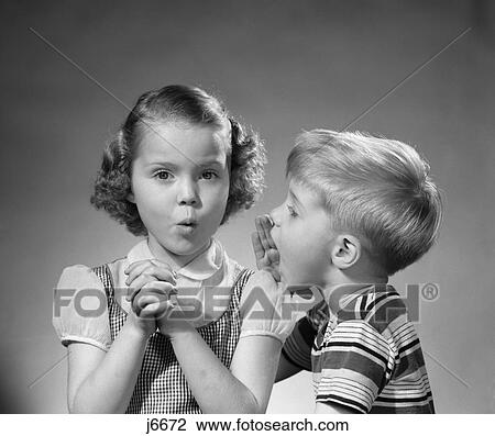 1950S Boy Whispering In Girls Ear Secret Rumor Gossip View Large Photo Image Stock Image - 1950S Boy Whispering In Girls Ear Secret Rumor Gossip . Fotosearch