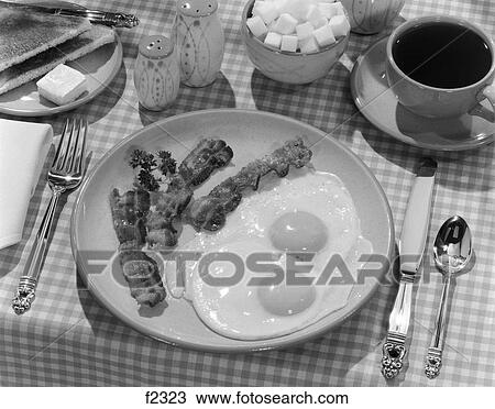 1950S Breakfast Plate Of Bacon & Fried Eggs & Coffee Sugar Bowl Toast Salt & Pepper Shakers On Checkered Tablecloth View Large Photo Image Stock Image - 1950S Breakfast Plate Of Bacon & Fried Eggs & Coffee Sugar Bowl Toast Salt & Pepper Shakers On Checkered Tablecloth. Fotosearch