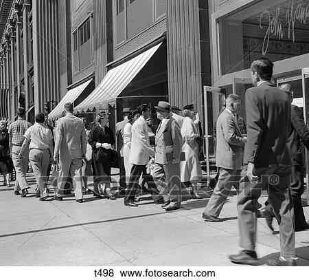 1950S Busy Sidewalk With People Walking In & Out Of John Wanamaker Building In Philadelphia View Large Photo Image Stock Photo - 1950S Busy Sidewalk With People Walking In & Out Of John Wanamaker Building In Philadelphia . Fotosearch