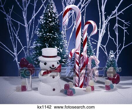 Stock Image - 1950S Christmas Table Top Styrofoam Snow Man Lollipops Gum Drops Candy Cane Canes Fake Trees White Twigs Branches Display. Fotosearch