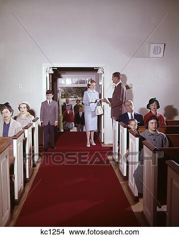 Picture - 1950S Church Interior Aisle People Men Women Children Seated In Pews & Entering Center Doors Family Congregation Worship . Fotosearch