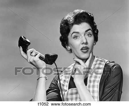 1950S Confused Woman Housewife Holding Up Telephone Receiver Facial Expression View Large Photo Image Stock Image - 1950S Confused Woman Housewife Holding Up Telephone Receiver Facial Expression . Fotosearch
