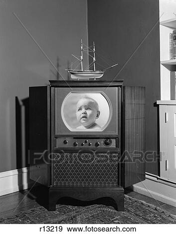 Stock Photo - 1950S Console Televsion Set Head On Baby Face Insert In Screen Model Ship On Top Dials Knobs Oriental Carpet . Fotosearch