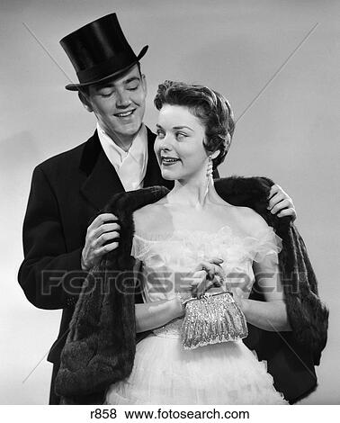 1950S Couple Formal Attire Man Wearing Top Hat Helping Woman Coat Fur Stole Evening Clothes View Large Photo Image Stock Photo - 1950S Couple Formal Attire Man Wearing Top Hat Helping Woman Coat Fur Stole Evening Clothes . Fotosearch