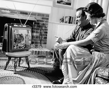 1950S Couple Husband And Wife Watching Tv In Living Room Smiling Indoor View Large Photo Image Stock Photo - 1950S Couple Husband And Wife Watching Tv In Living Room Smiling Indoor . Fotosearch