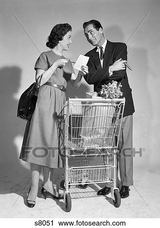 1950S Couple Man Woman Shopping Cart Reviewing Grocery List Man Has Cigar In Hand View Large Photo Image Stock Image - 1950S Couple Man Woman Shopping Cart Reviewing Grocery List Man Has Cigar In Hand . Fotosearch