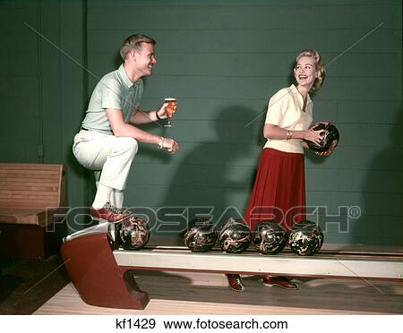 1950S Couple On Bowling Alley Woman Holding Ball Man With Glass Of Beer Indoor Sports View Large Photo Image Stock Photo - 1950S Couple On Bowling Alley Woman Holding Ball Man With Glass Of Beer Indoor Sports . Fotosearch