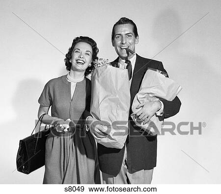 1950S Couple Smiling Woman Man Carrying Grocery Baghs Smoking Cigar Seamless View Large Photo Image Stock Photo - 1950S Couple Smiling Woman Man Carrying Grocery Baghs Smoking Cigar Seamless . Fotosearch